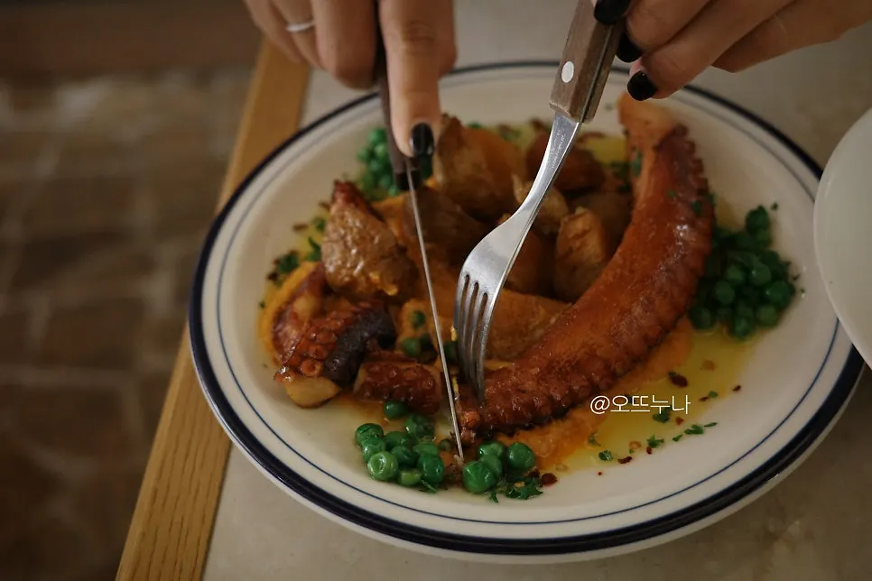 Pulpo mambo plate with potatoes, peas, and sauce