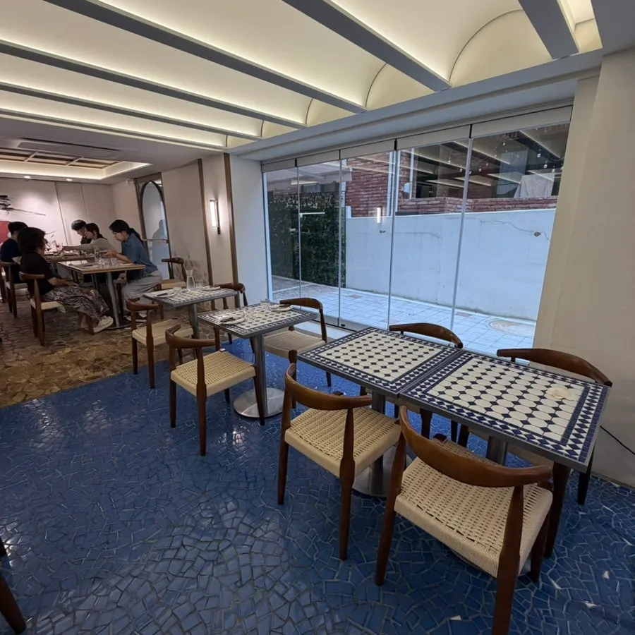 Interior lit by floor-to-ceiling windows