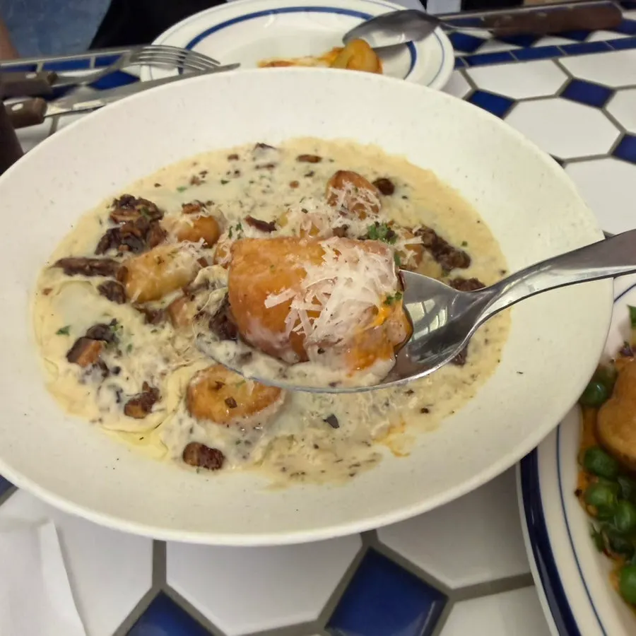Cross-section of gnocchi topped with cream sauce