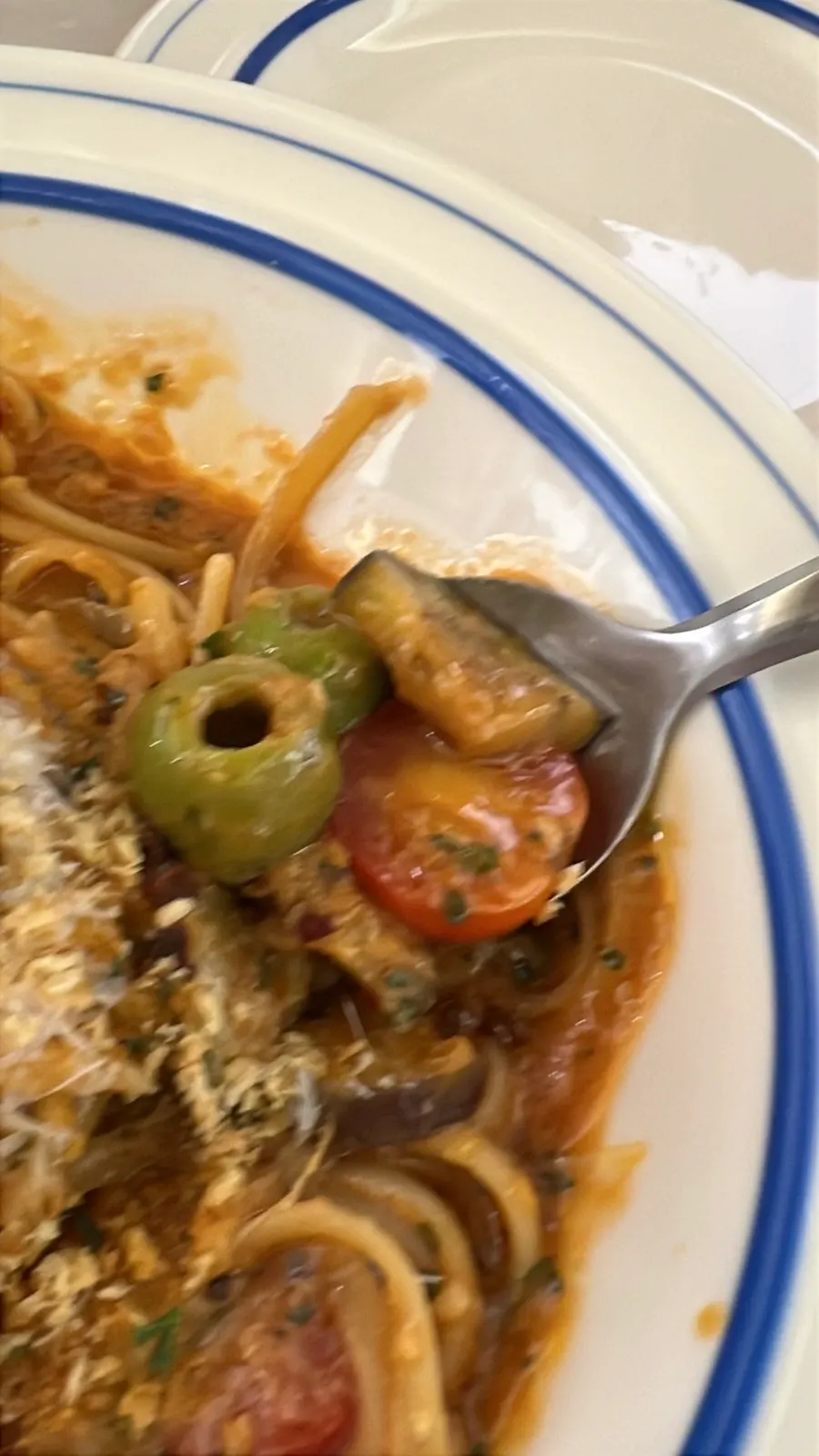 Sicilian puttanesca pasta twirled on a fork