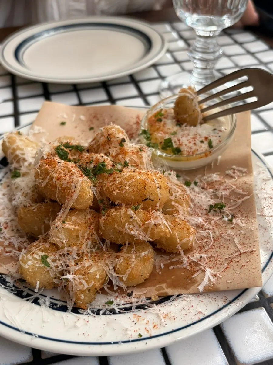 Fried gnocchi coated in herb cream
