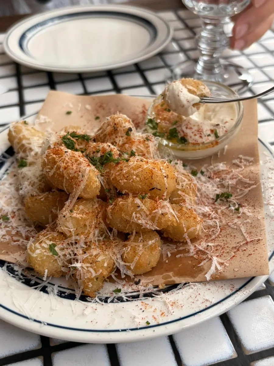 Gnocchi fritters served alongside wine