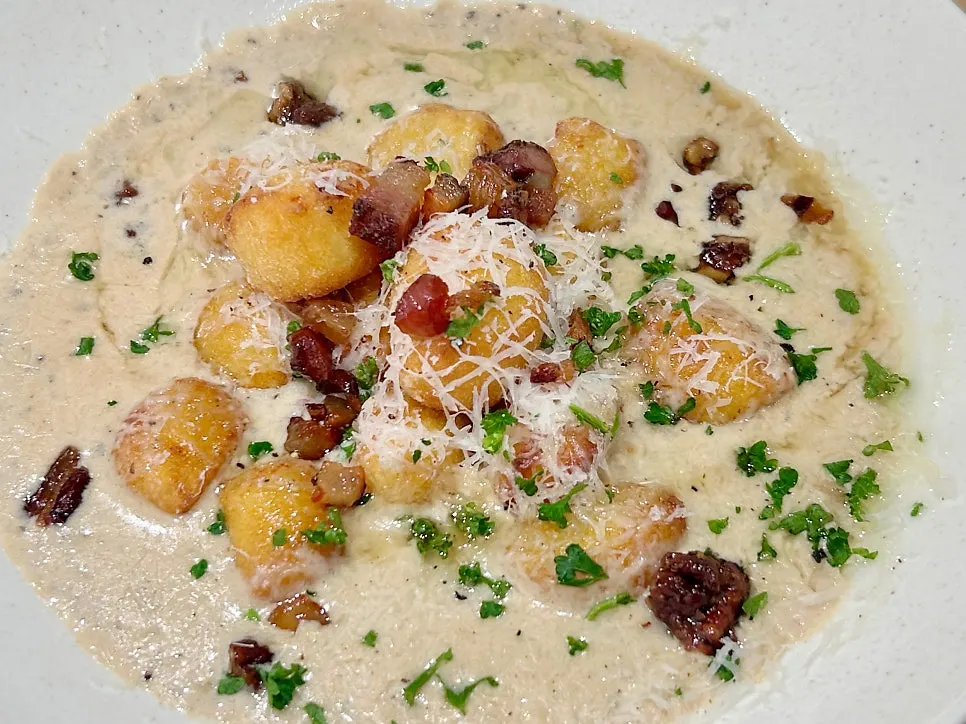 A plate of gorgonzola truffle cream gnocchi