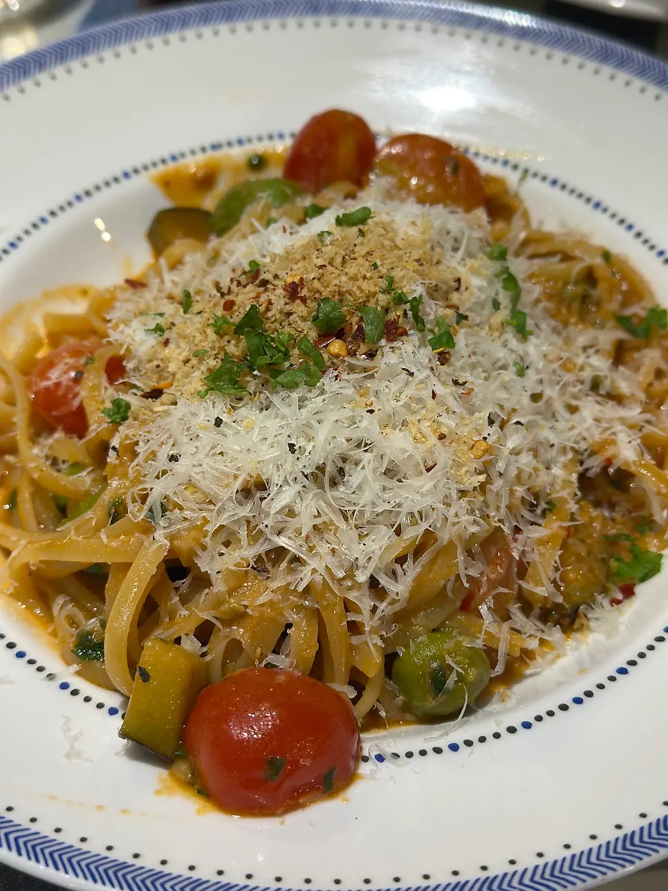 Tomato pasta with visible eggplant and olives