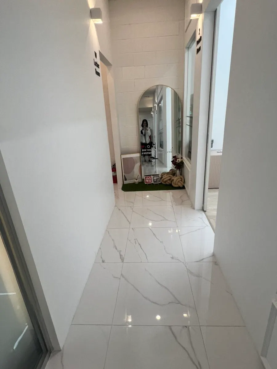 Hallway to the changing room with a large mirror