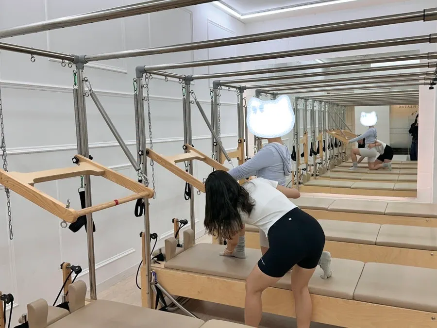 Instructor correcting a member's posture during group class