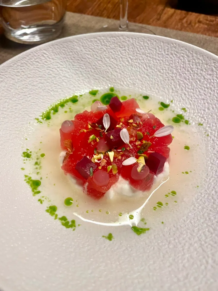 Close-up of smoked watermelon appetizer with tomato water
