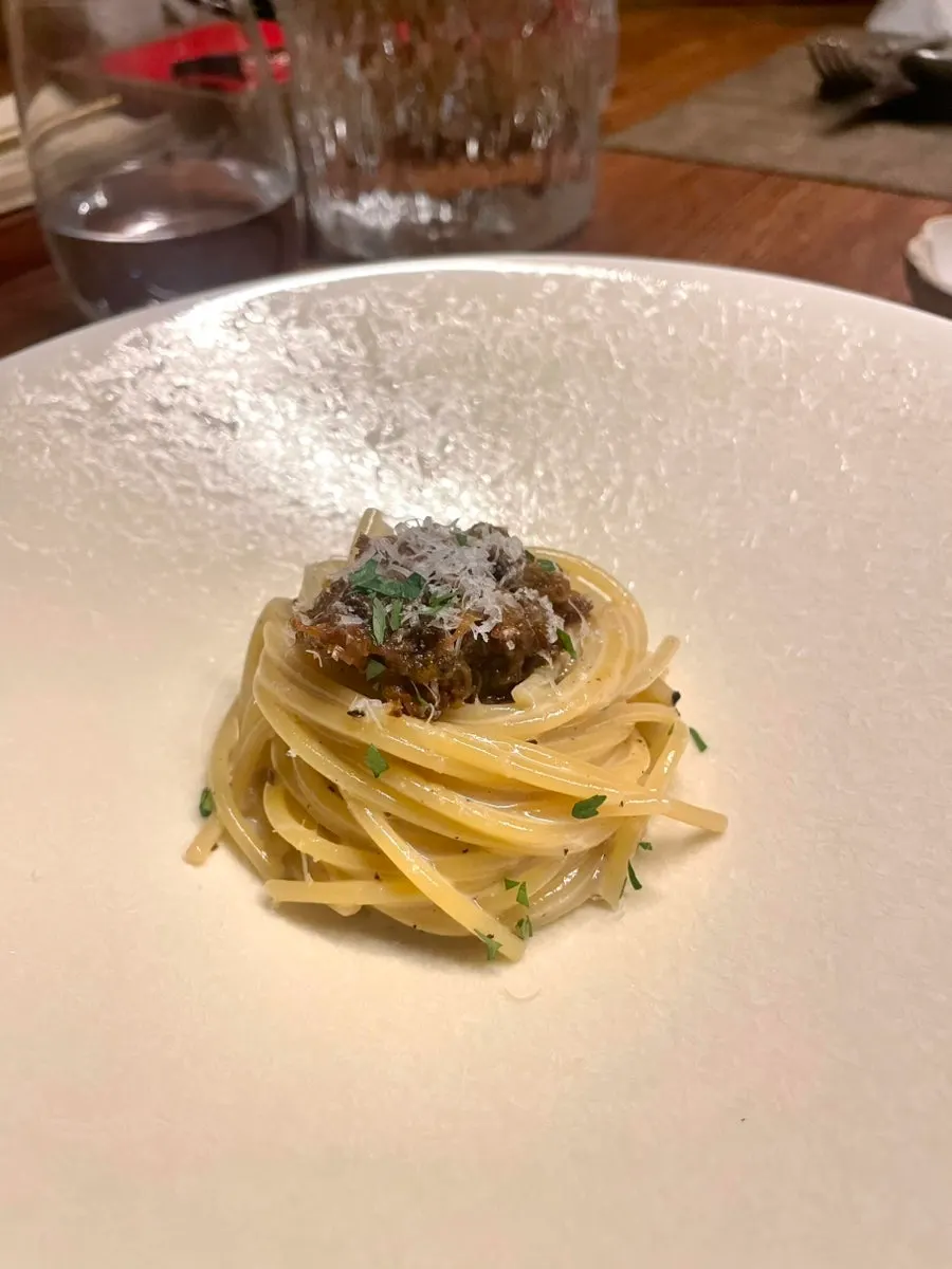 Genovese ragu pasta served on a large center plate