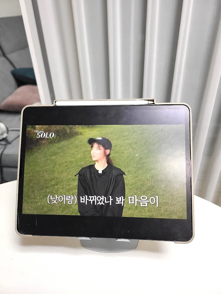 Tablet stand supporting a laptop