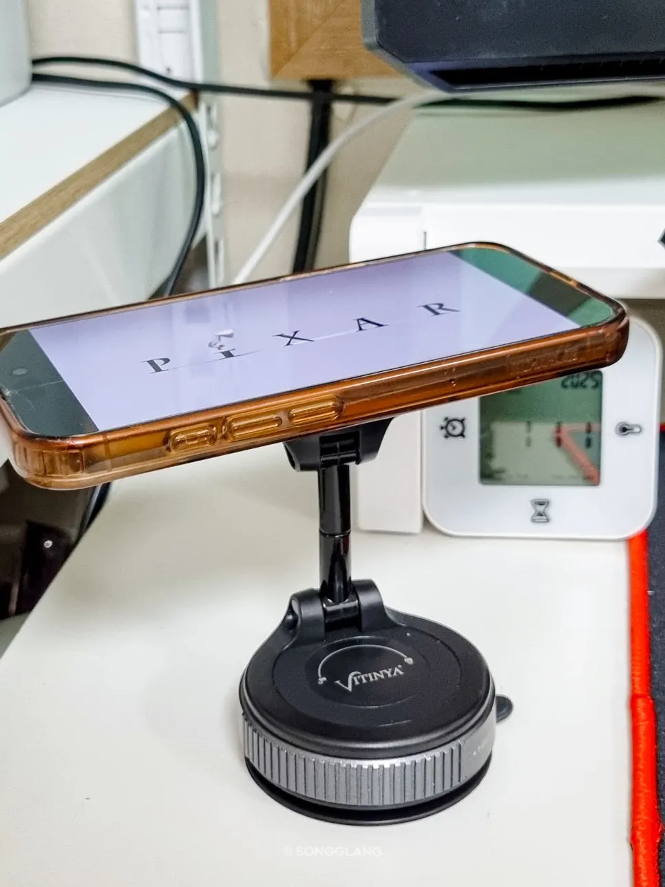 Phone mounted on a computer desk