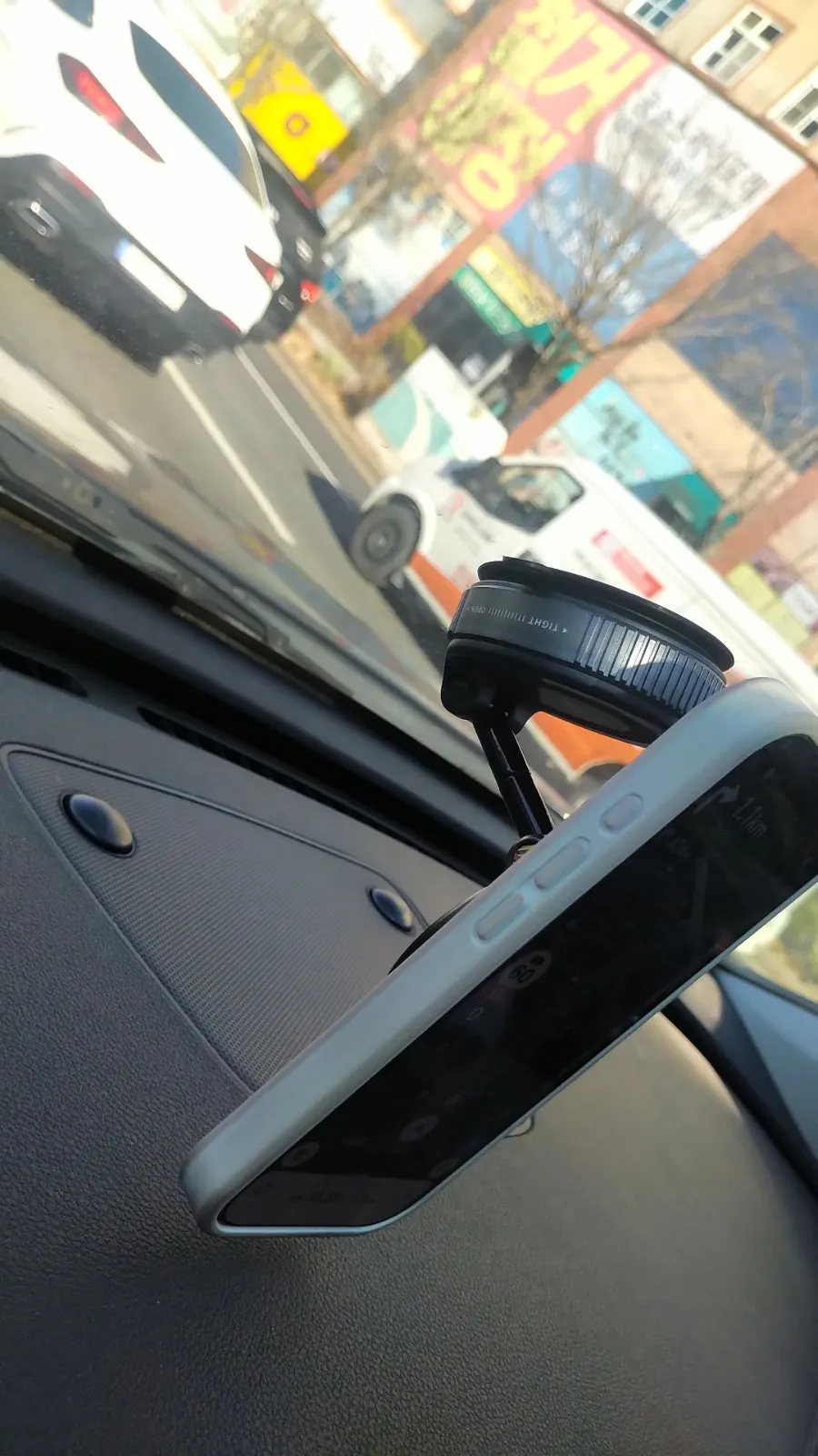 Car phone mount attached to a windshield
