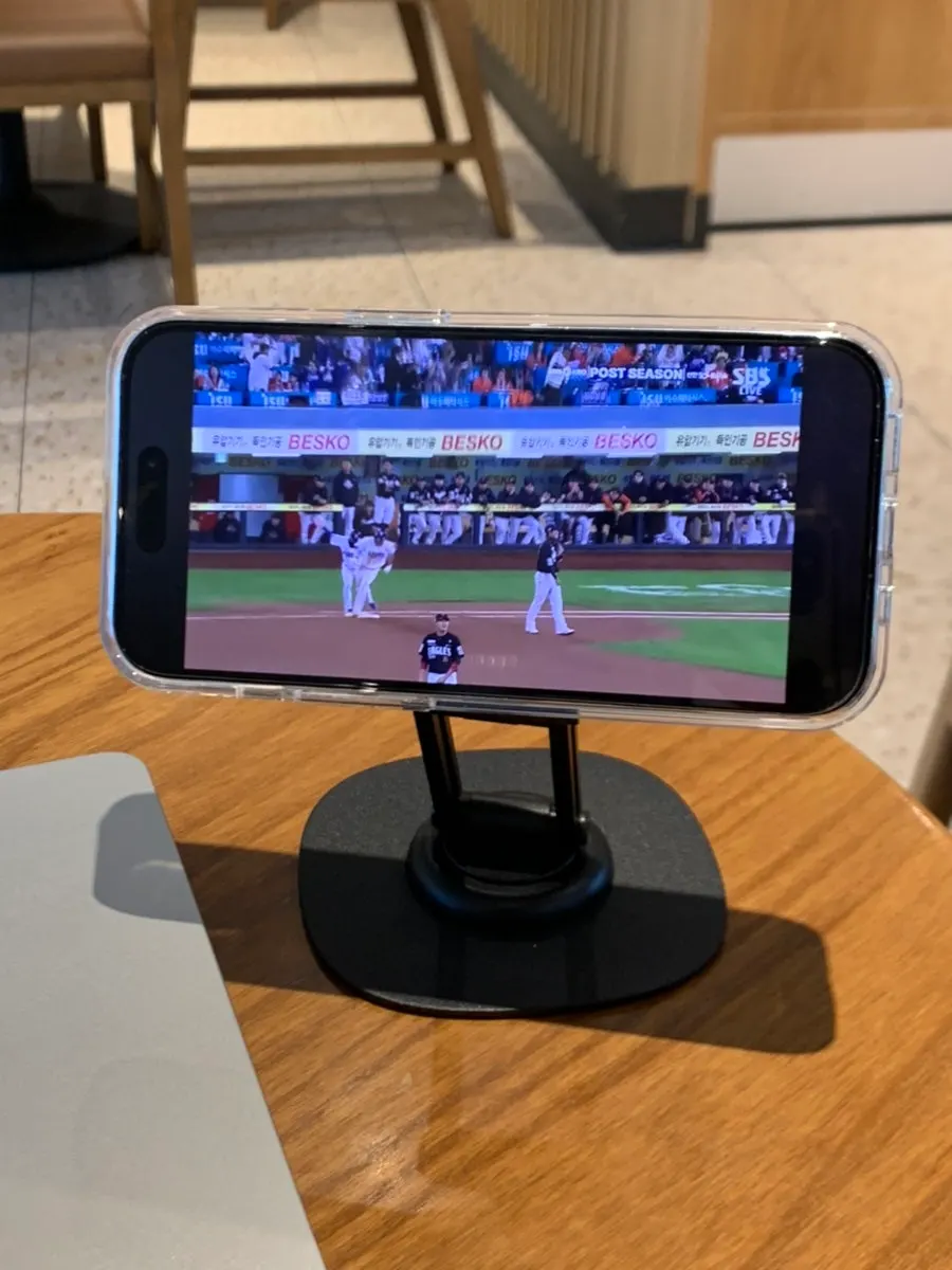 Phone stand beside a laptop