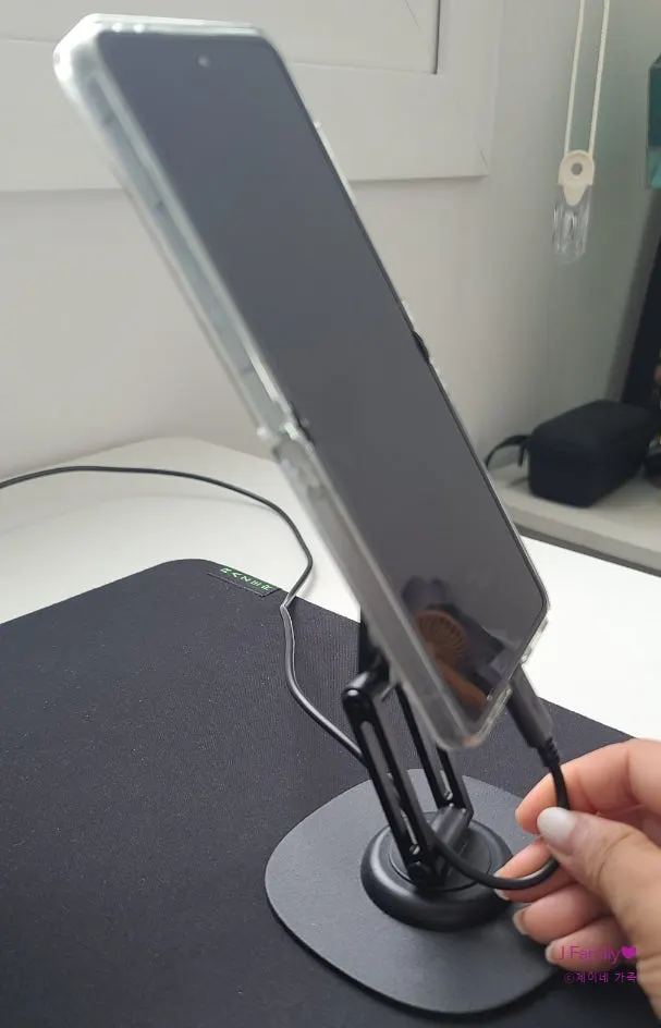 Stand with a phone attached by MagSafe
