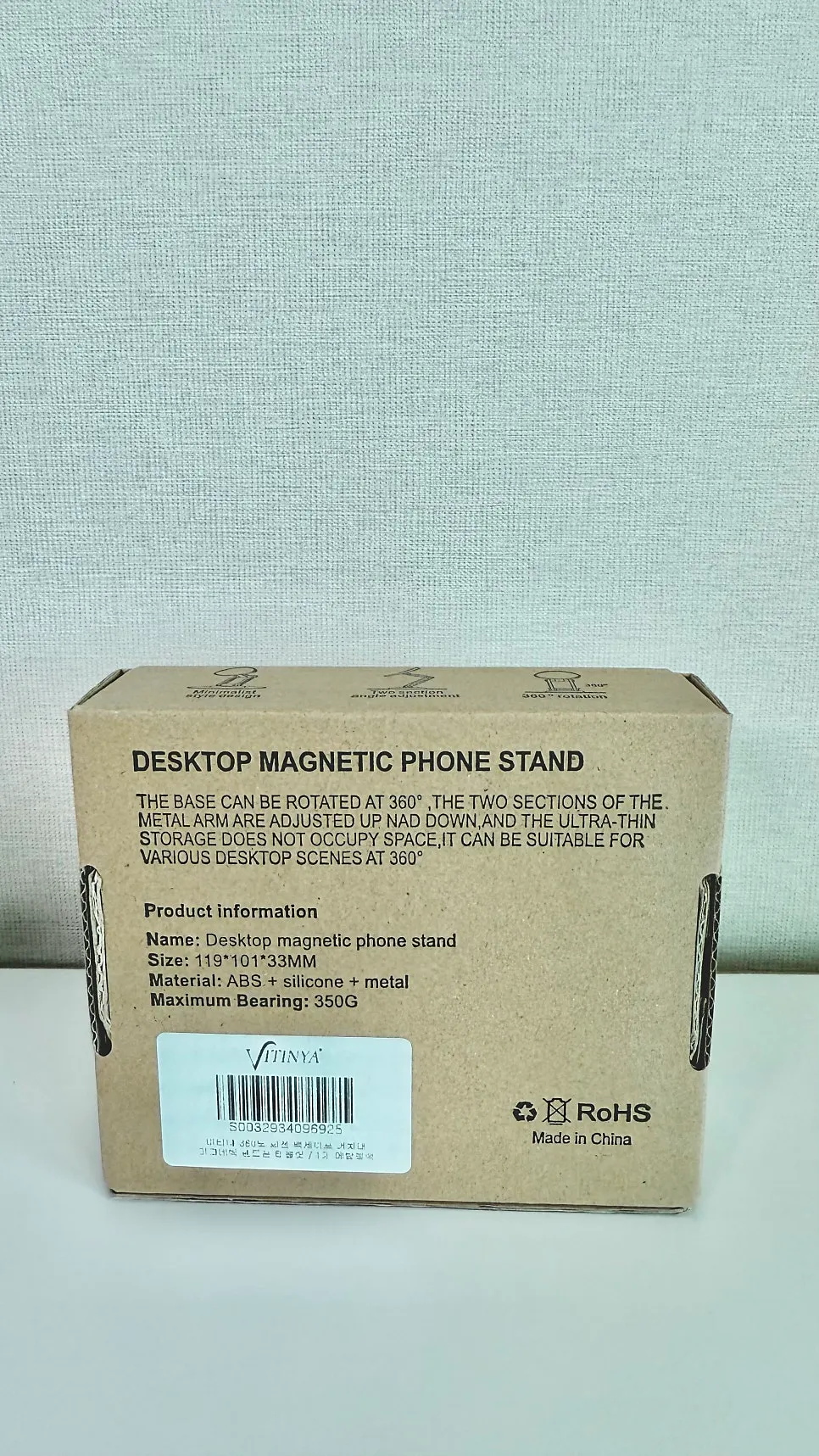 Phone propped against a cup and a MagSafe stand