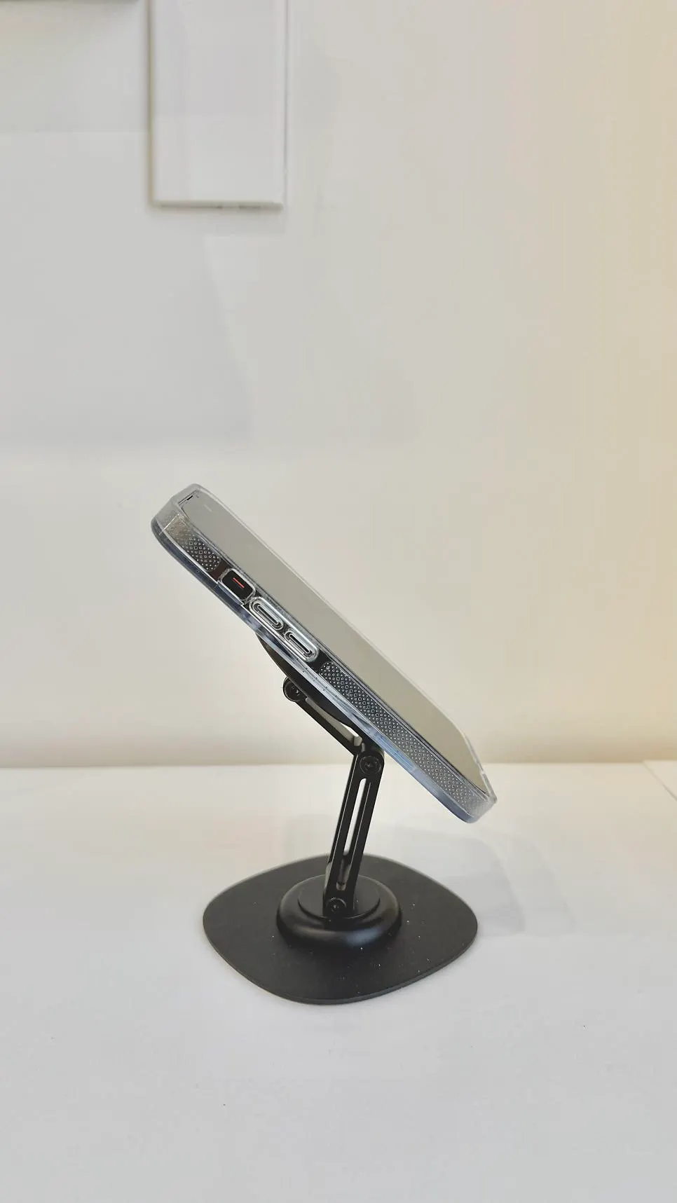 A phone with a case magnetically mounted on the stand
