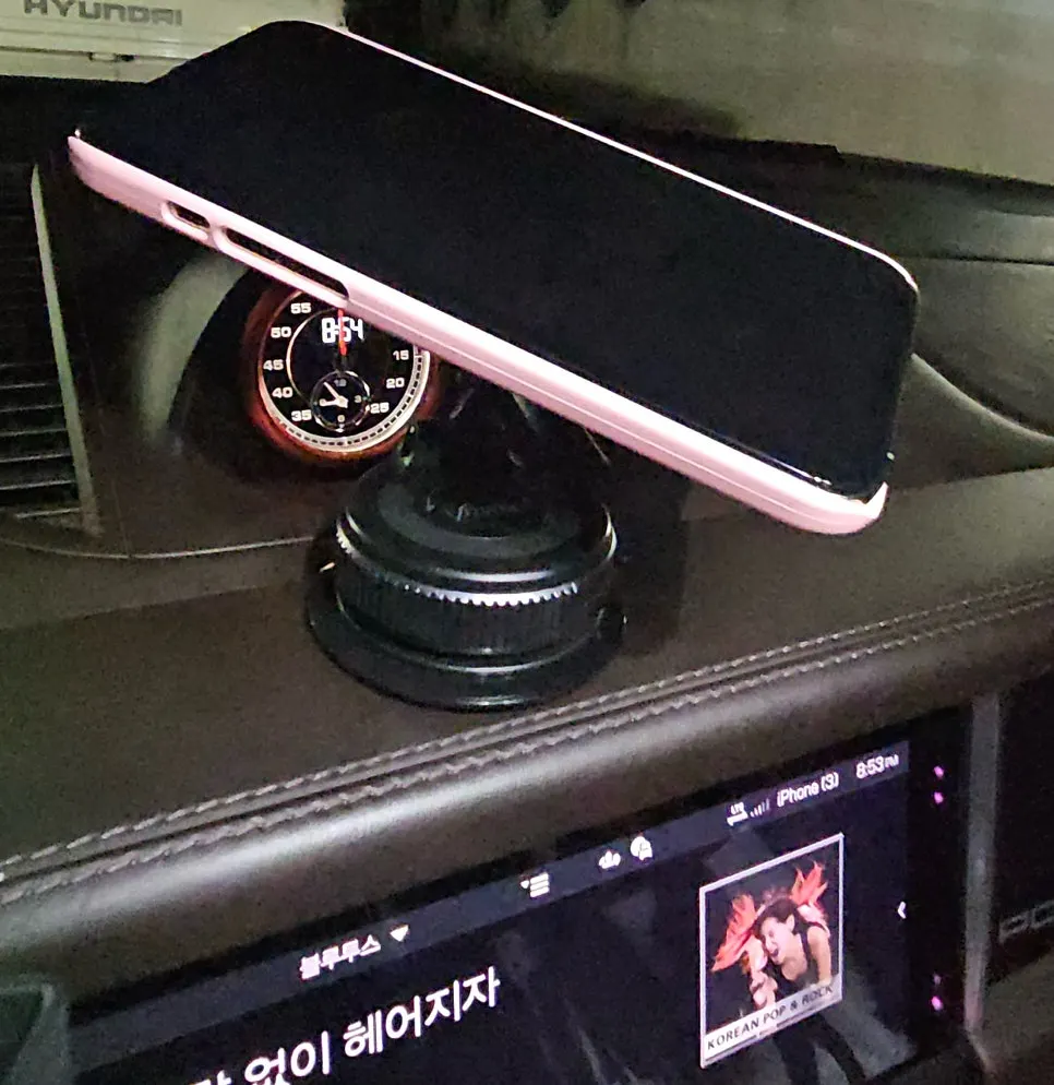 iPhone held magnetically on the car mount
