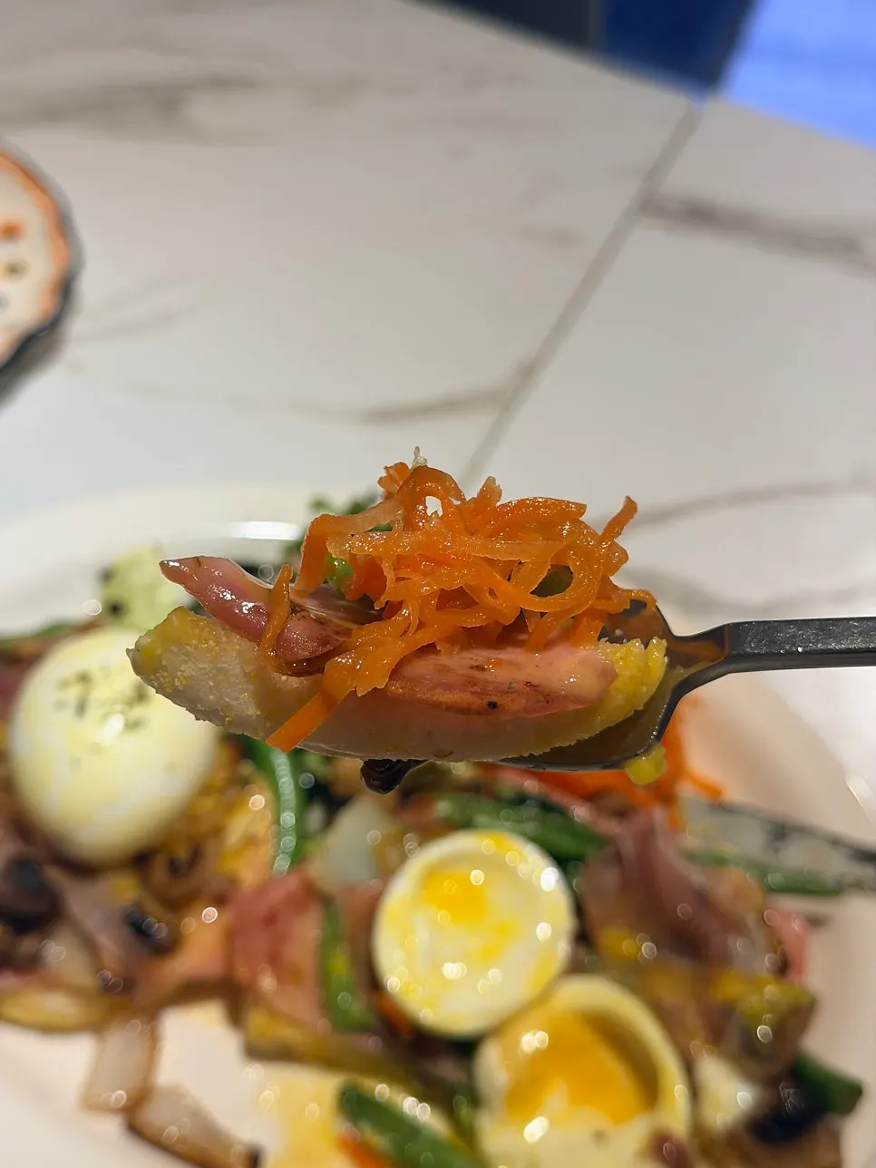 Egg Benedict and salad photographed in sunlight by the window