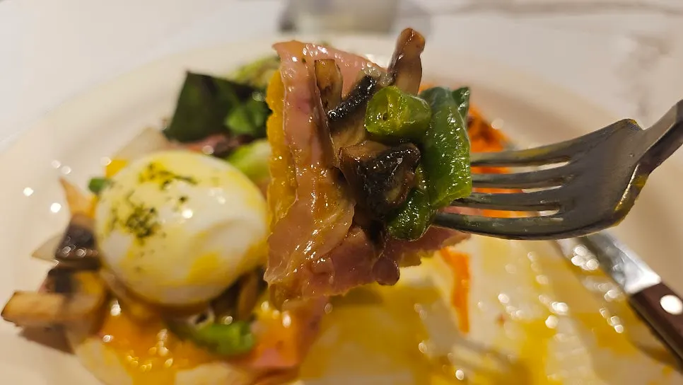Salad served alongside the eggs Benedict