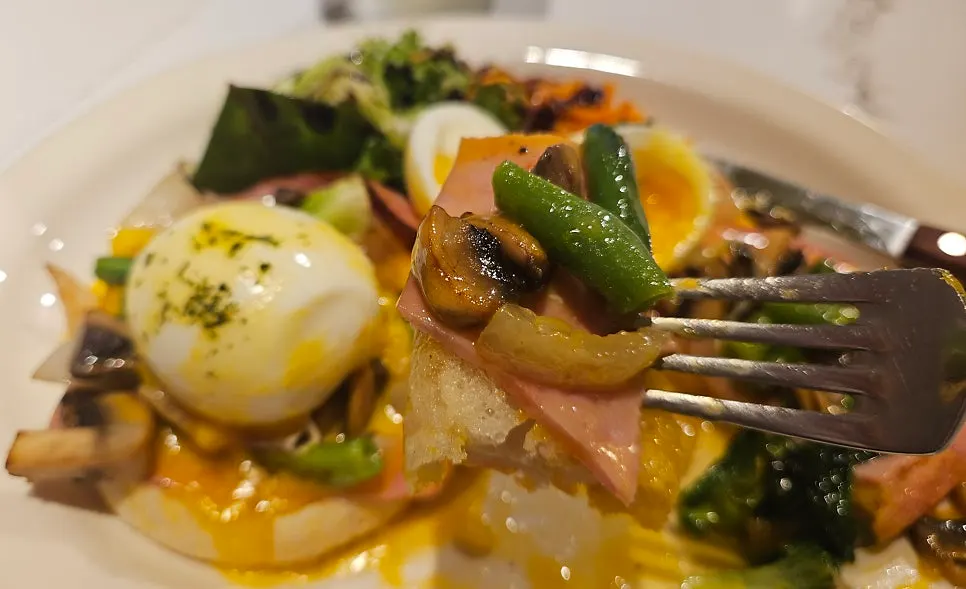 Hollandaise sauce over the English muffin