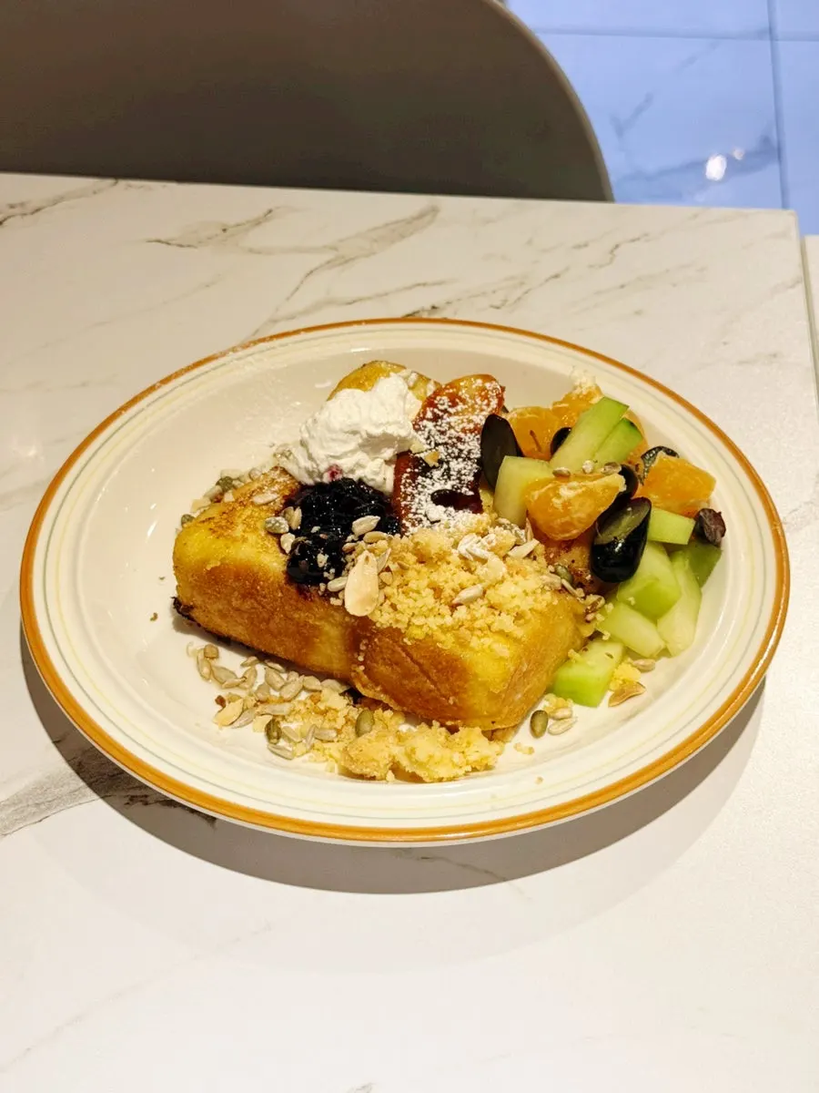 Vivid French Toast topped with cream and fruit