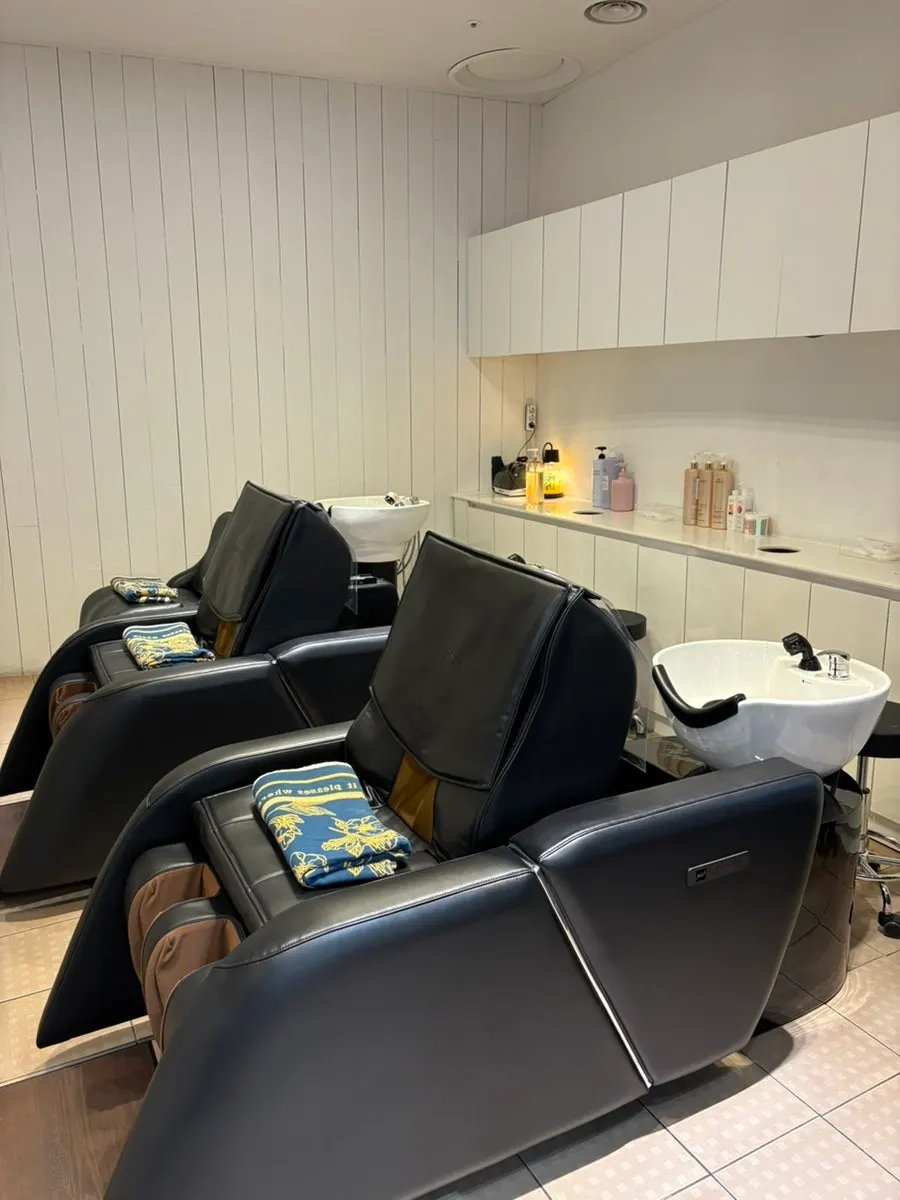 Shampoo room with massage chairs at VOG HAIR