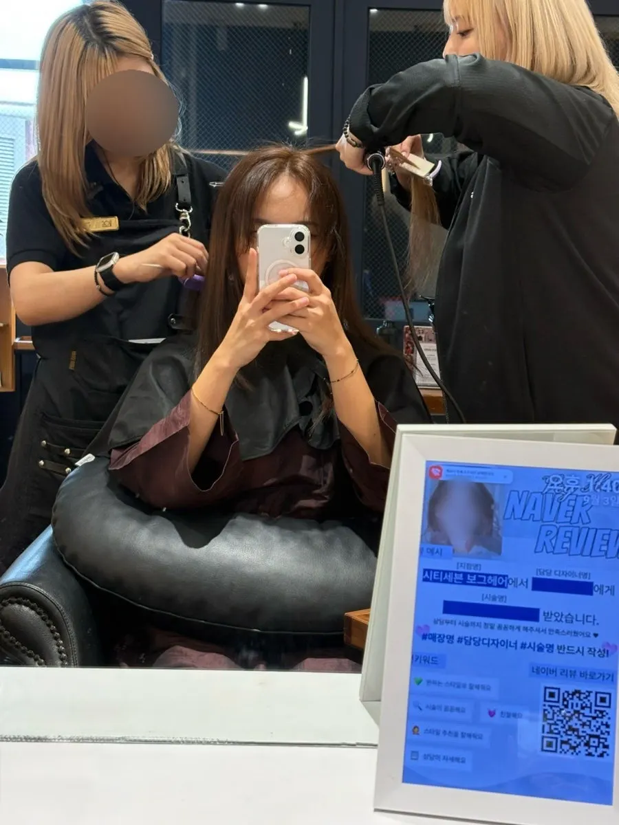 Straightening iron being used to flatten hair