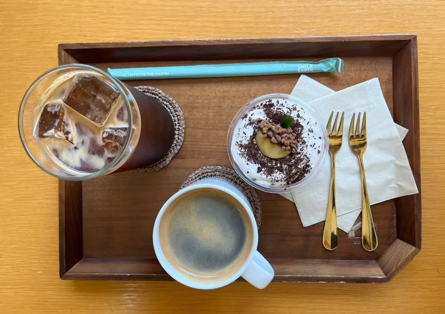 Chestnut tiramisu and Americano on a wooden tray