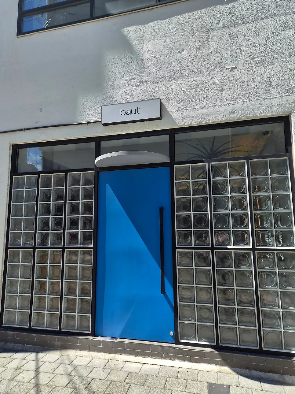 Baut's clean exterior and blue entrance door