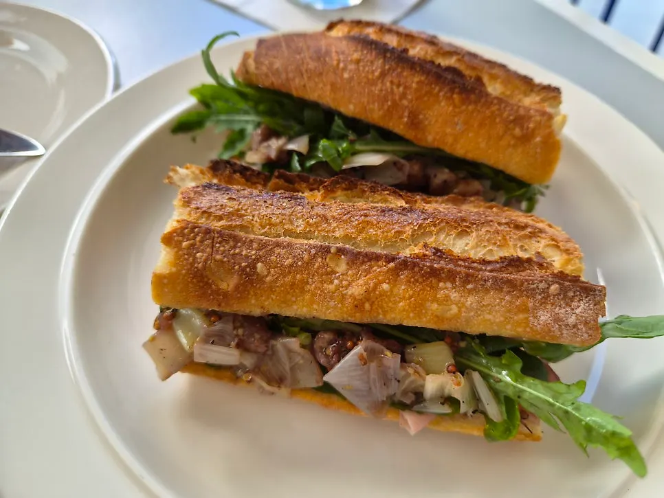 A plate with Baut's green onion jambon sandwich