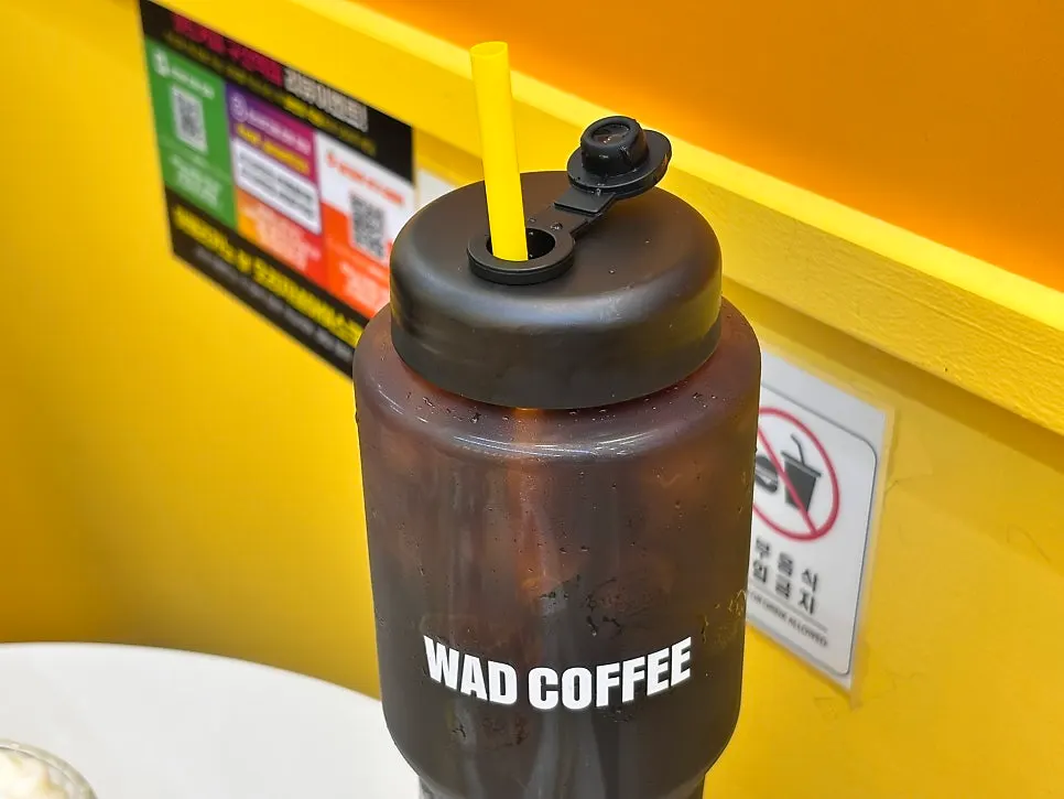 1L bottle cold brew with a straw in it