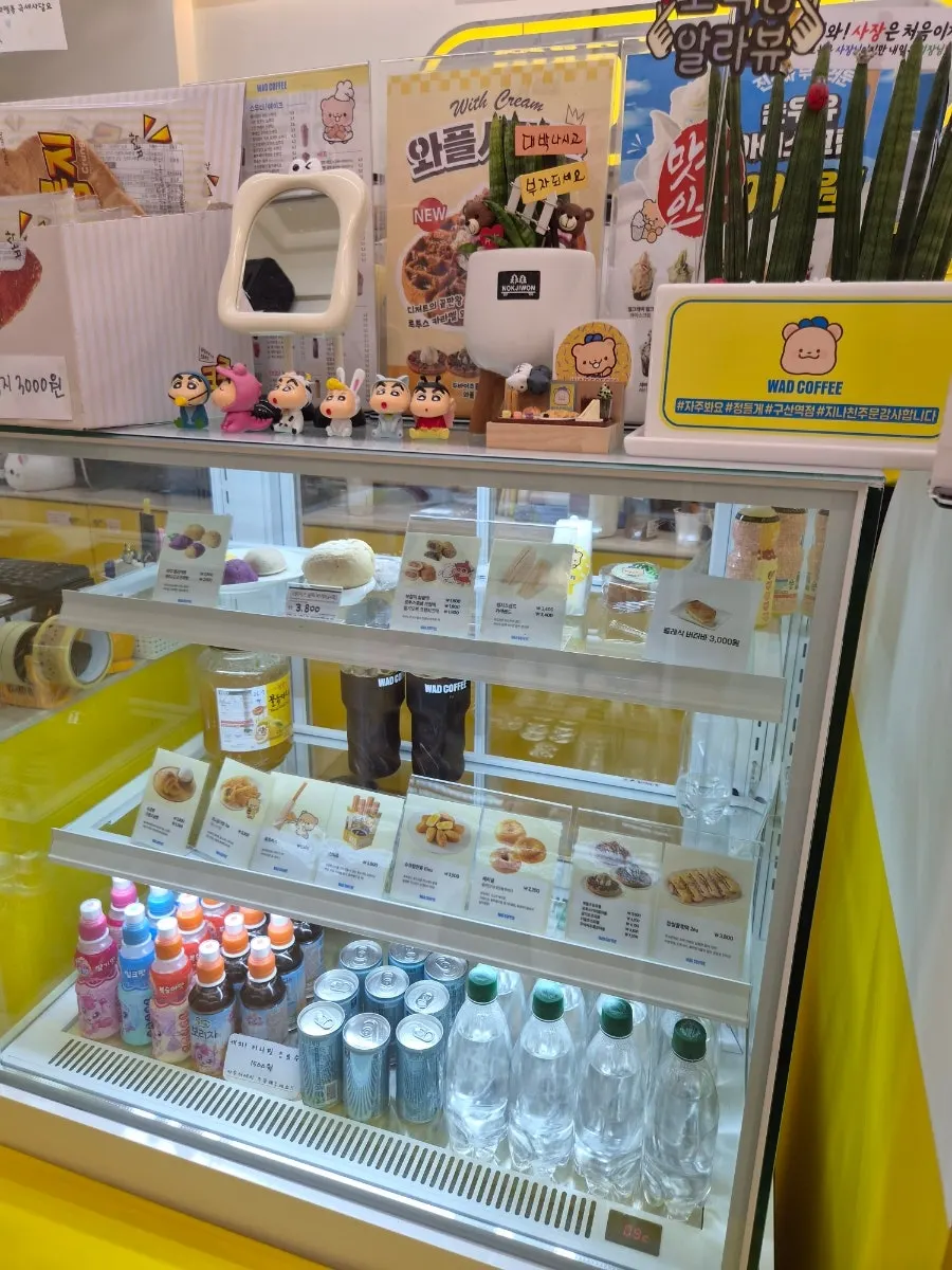 Interior of Ward Coffee Gusan Station Branch decorated with plushies and figures
