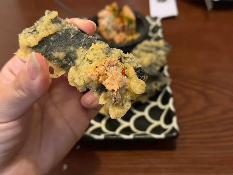 A bite of gim-bugak topped with ankimo