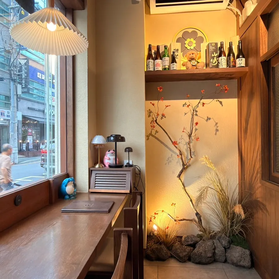 Softly lit seating area inside Wakoan Beomeo Branch