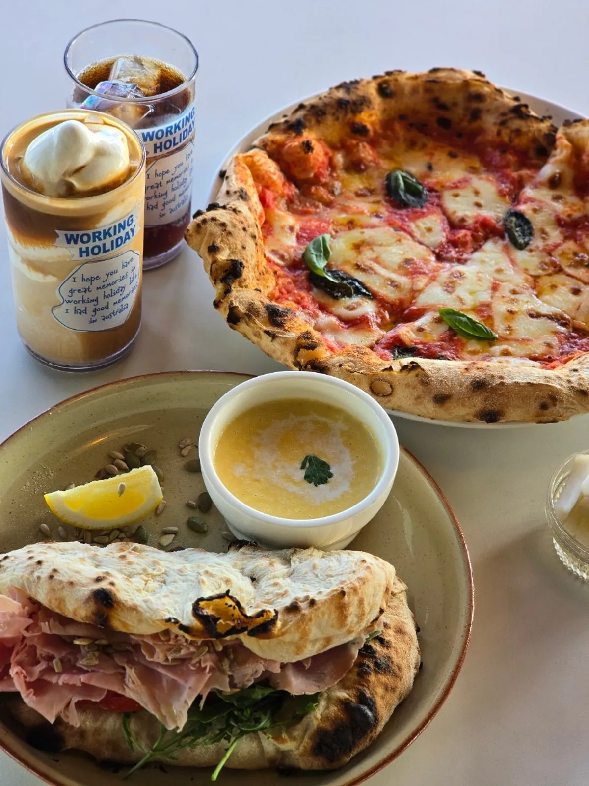 Full shot of Margherita pizza and panuozzo by the Gwangan Bridge-view window