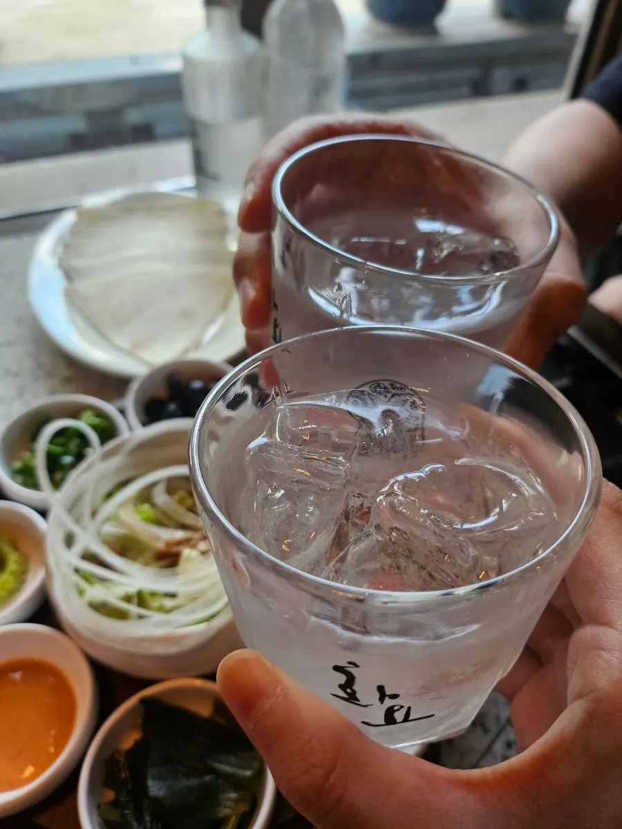 Soju poured into a Hwayo-branded glass