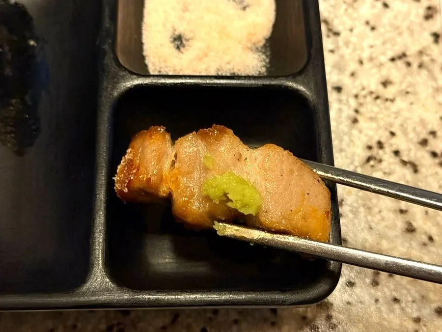 A piece of pork belly topped with shiitake wasabi