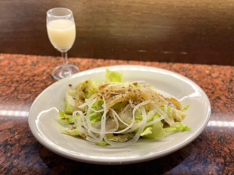 A glass of yuja makgeolli served as a welcome drink
