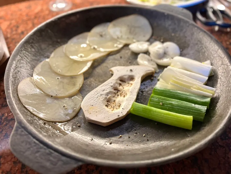 Potato, scallion, and mushroom grilling on the pan