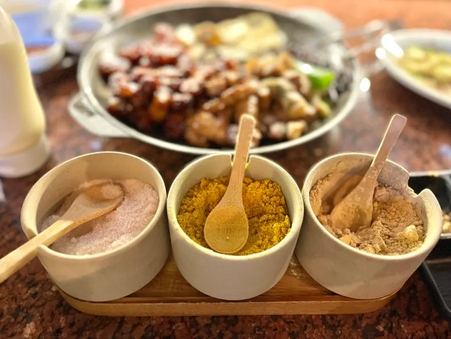 Plate of mayonnaise, salt, curry powder, and soybean powder accompaniments
