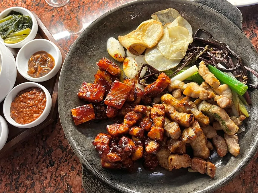 A platter of aged, galbi-seasoned, and gochujang-seasoned pork belly