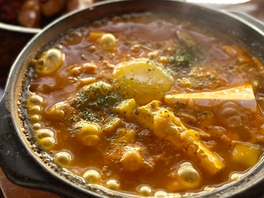 Doenjang risotto topped with cheese and egg yolk