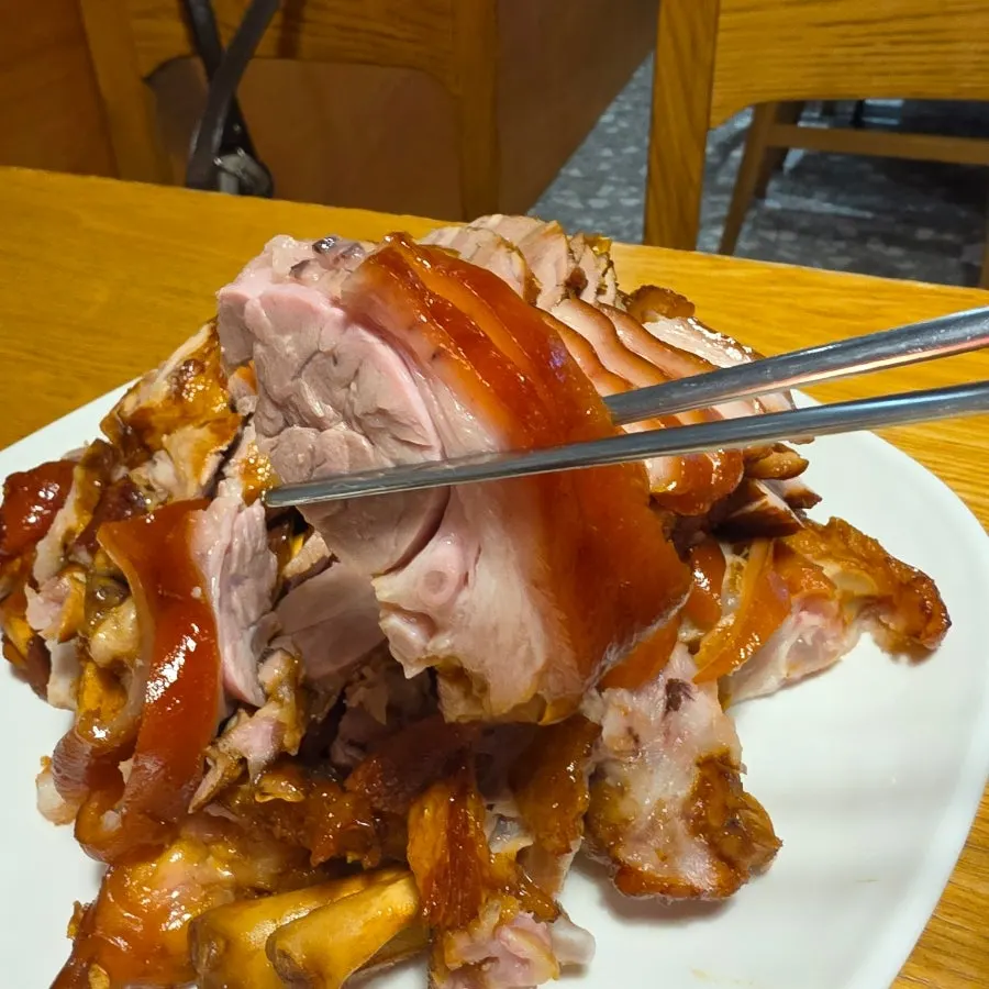 A piece of jokbal dipped in sauce