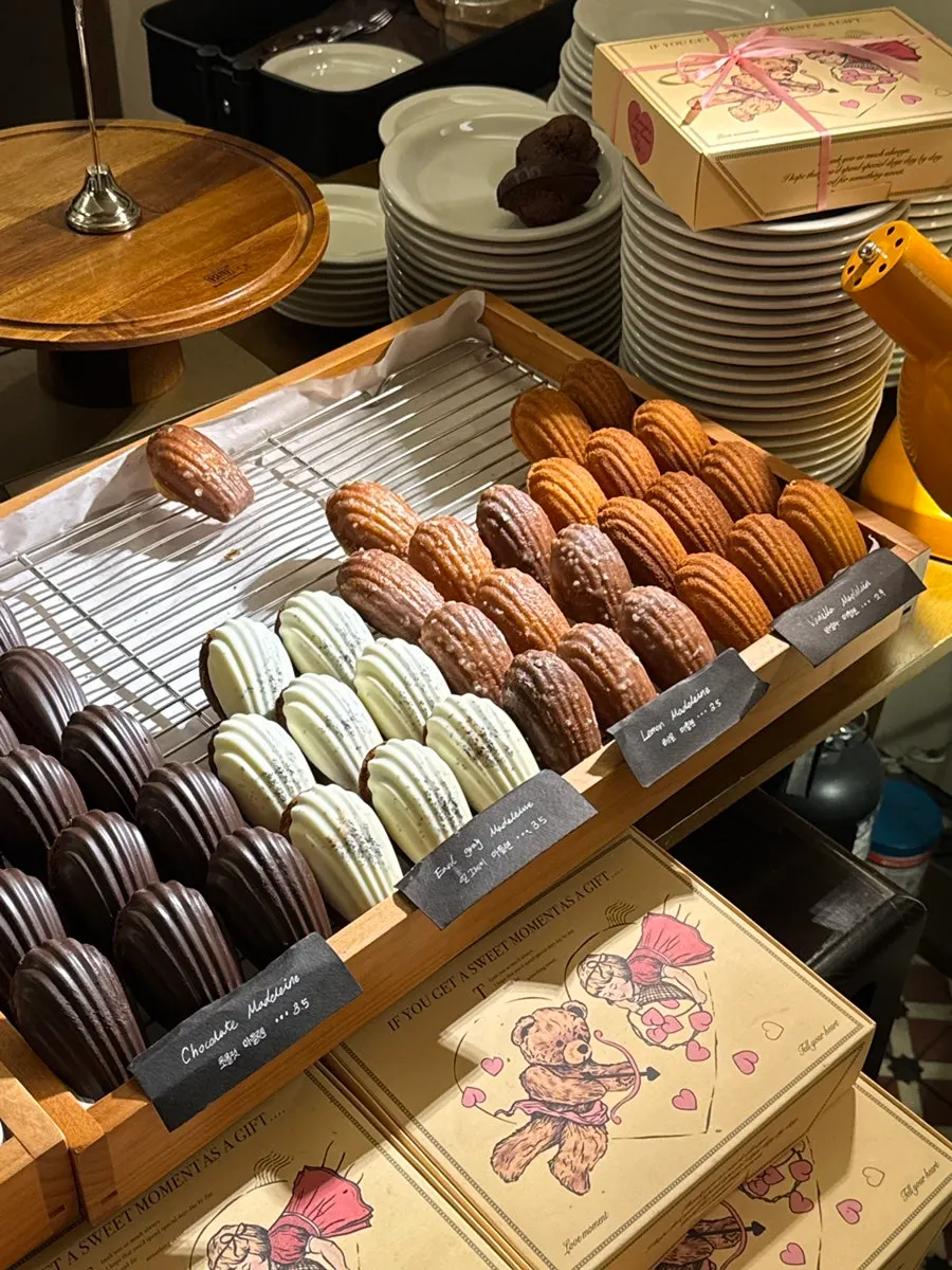 Chocolate, Earl Grey, and lemon madeleines on display