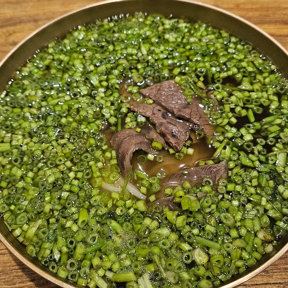 Gomtang meat sitting beneath the minari