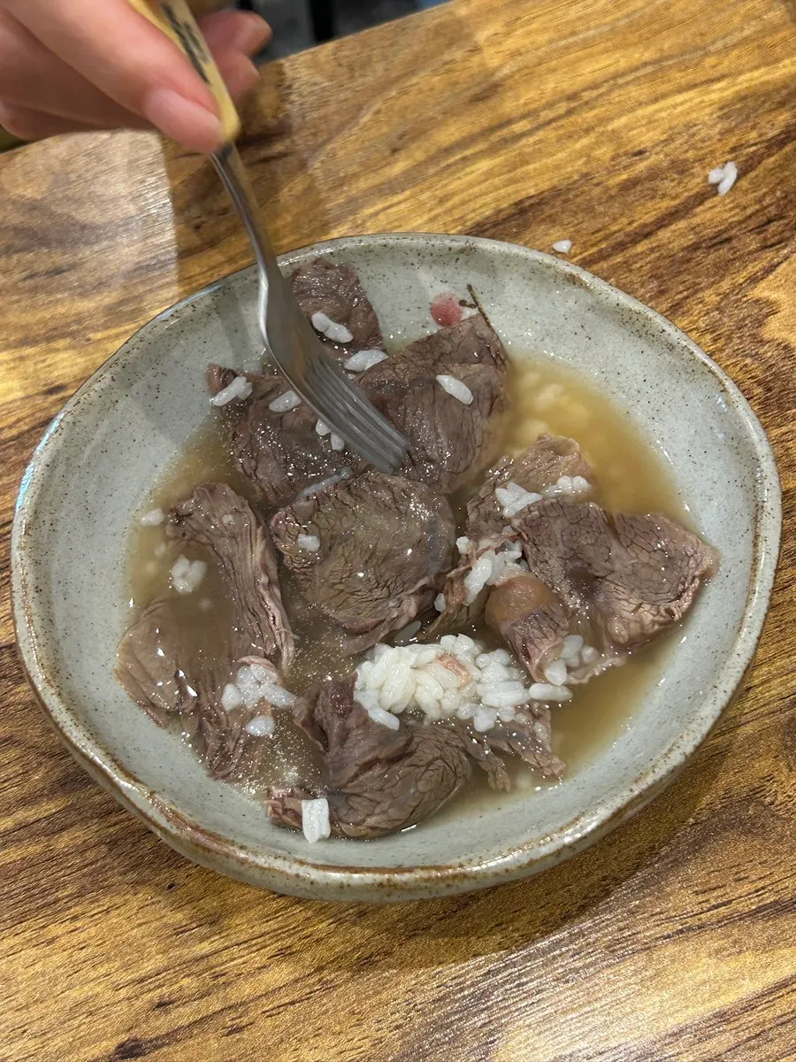 Broth and rice scooped into baby dishware