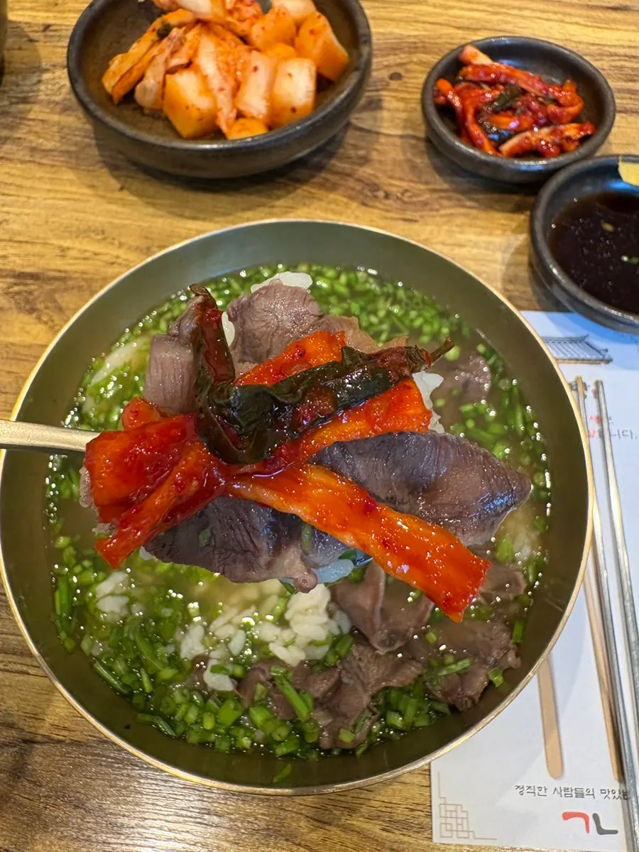 A close-up of the minari gomtang broth and beef