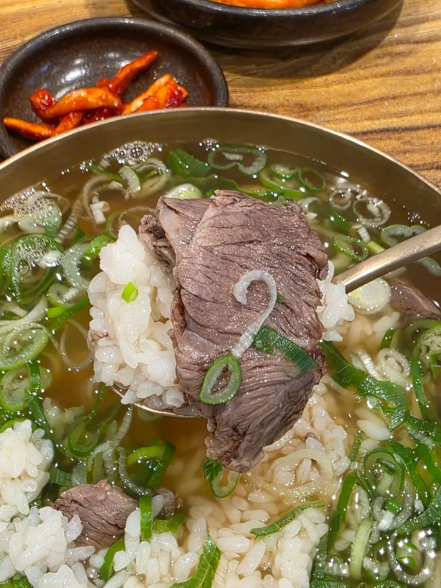 Gomtang broth topped with plenty of green onion