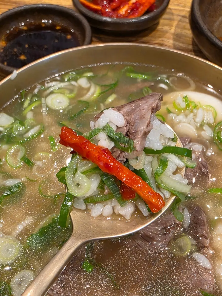 A piece of Korean beef dipped in sauce