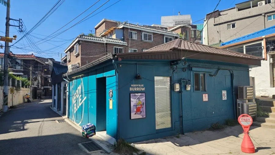 Exterior of Nerdy Blue Burrow tucked into an alley