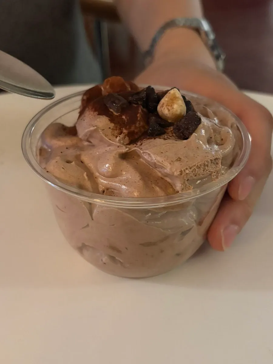 Nerdy Milk topped with cream and cocoa powder